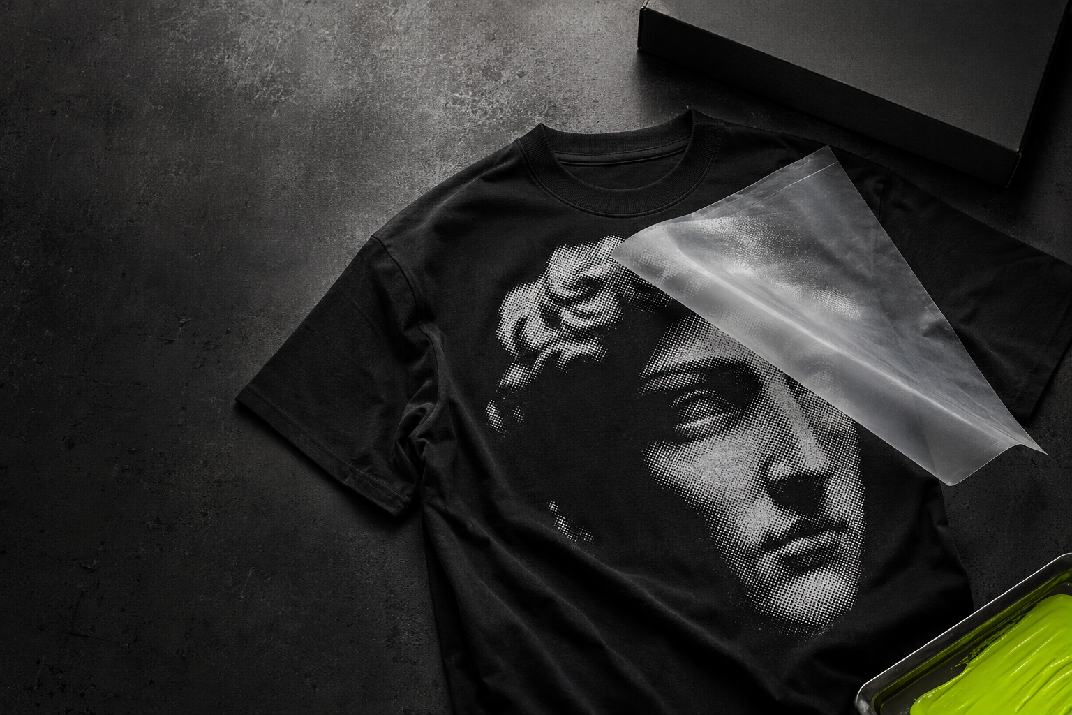 Black graphic tee with monochrome artwork and translucent DTF transfer film